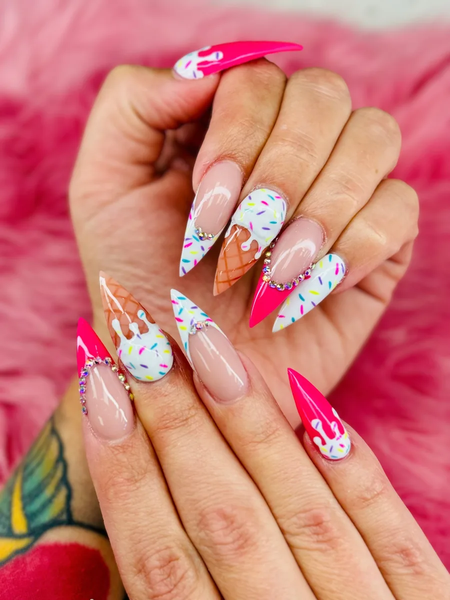Long stiletto nails in nude, hot pink and white with ice cream cone, drip and rainbow sprinkle art and crystal accents by Hailey Nguyen